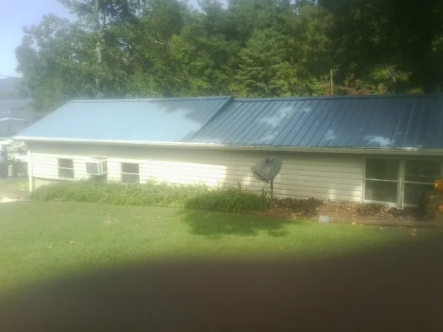 Blue metal roof running the length of a single story home in Dawson